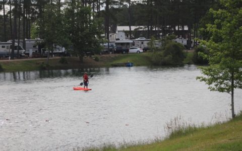 Man standing in canoe on the beautiful lake