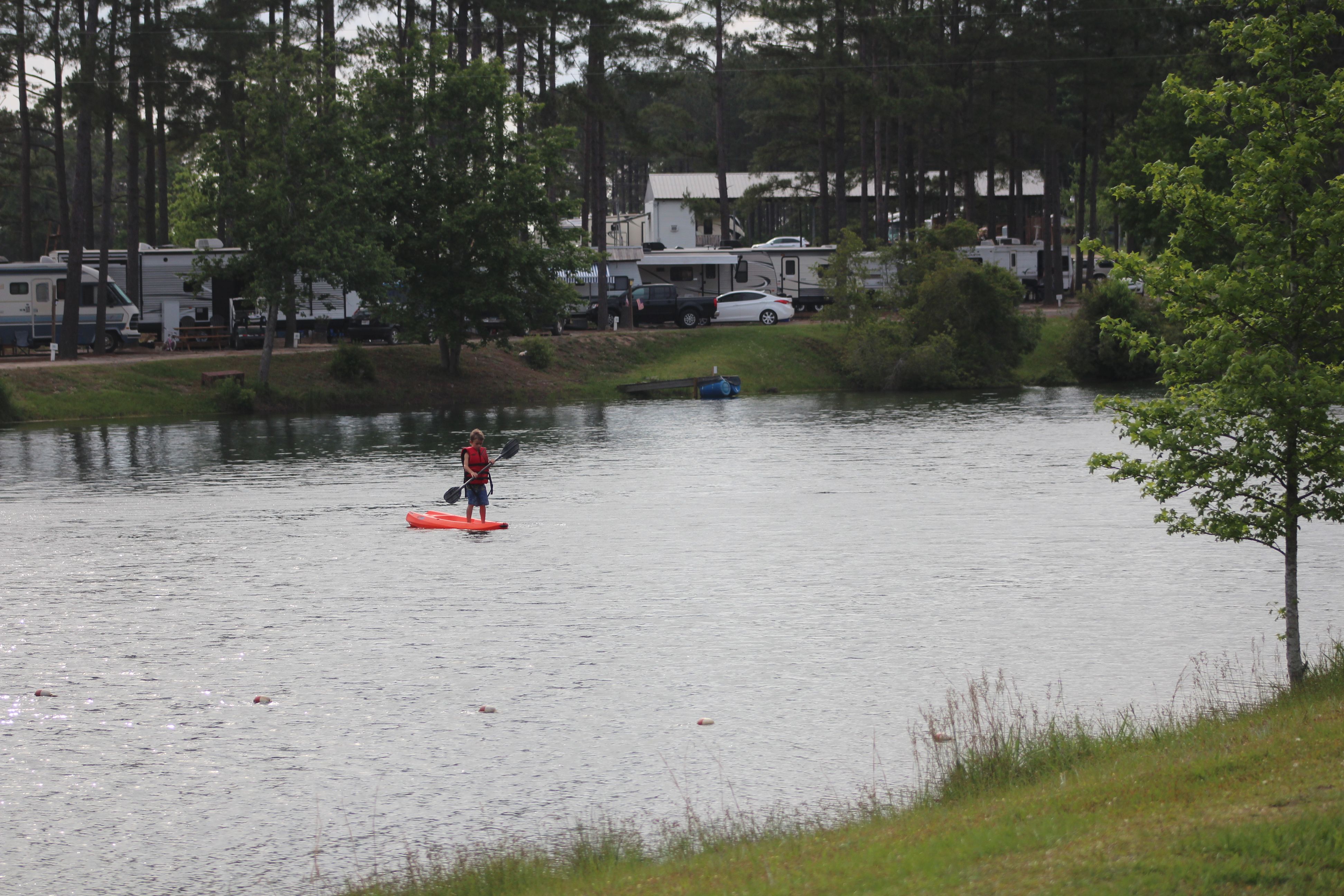 Man standing in canoe on the beautiful lake